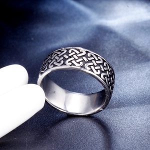 Macro side view of silver Viking ring with Celtic knot relief on stainless steel band