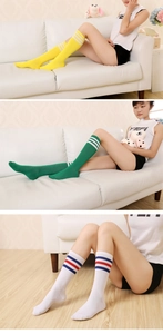 Detailed view of knee-high socks with stripes in yellow, green, and white colorways