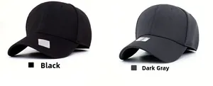 Close-up of black and dark grey fitted baseball caps with breathable fabric texture