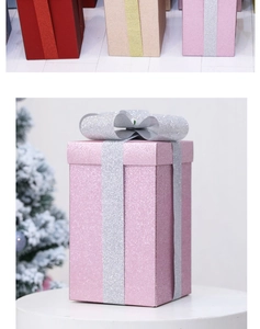 Close-up of matte glitter gift boxes with silver ribbons for Christmas tree decor