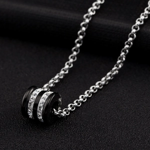 Men's titanium steel necklace featuring a black cylinder pendant with clear crystal rows