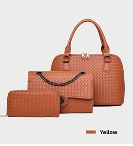 Detailed view of woven yellow three-piece bag set with tote, crossbody, and wallet