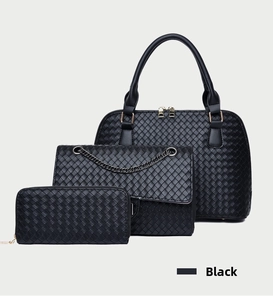 Detailed view of black 3-piece bag set with woven texture and gold hardware details