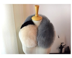 Detailed view of three-tone faux fox fur scarf in smoky gray, black and khaki colors