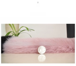 Close-up of pink and black faux fox fur texture with a coin for size reference