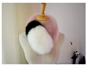 Detail of faux fox fur scarf in pink, black and white tricolor patchwork design