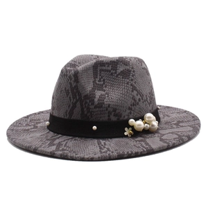 Detail of grey snakeskin wool fedora with black ribbon, white pearls and gold ornament