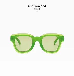 Close-up of translucent green vintage sunglasses with metal rivet details and yellow lenses