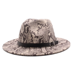 Detail of the black leather belt and silver buckle on a snakeskin patterned fedora hat