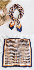 Detailed view of geometric pattern square scarf with orange and navy blue silk texture