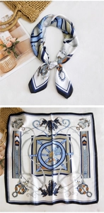Detail of nautical print silk scarf with anchor and helm patterns on a textured background