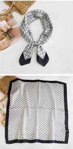 Detail of satin square scarf featuring black and white chain patterns and wide borders