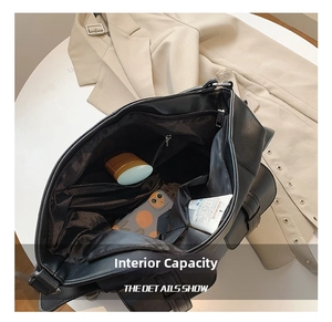 Detailed interior view of a black tote bag showing large capacity and multi-pocket design