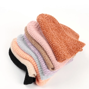 Stack of colorful knitted bucket hats in soft plush material for winter warmth