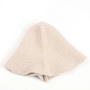 Close-up of soft beige knit bucket hat texture in plush faux rabbit fur material