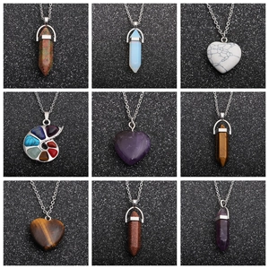 Set of crystal pendant necklaces featuring hexagonal points and hearts on dark background