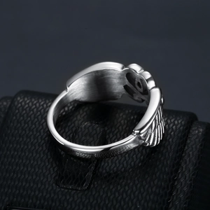 Punk style silver stainless steel ring with heart wing relief on a premium gift box