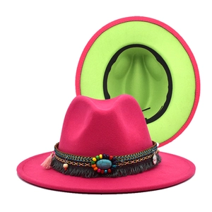 Detail of wool fedora hat with fuchsia exterior, green lining, and turquoise bead trim