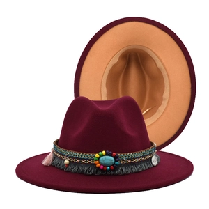 Detail of burgundy wool fedora with turquoise bead band and beige interior lining