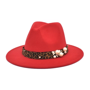 Detail of red fedora hat featuring leopard print band and white pearl flower accents
