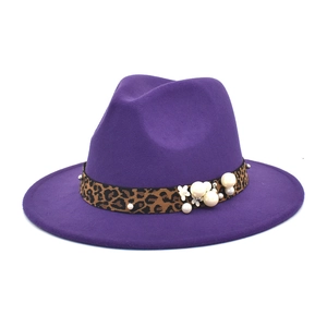 Detail of purple fedora hat featuring leopard print band with pearls and floral accent