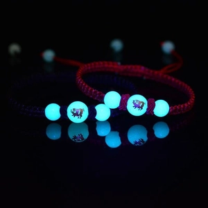 Luminous handmade woven zodiac red and blue rope bracelets glowing in the dark for couples