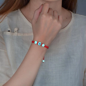 Handmade red braided cord bracelet featuring glowing luminous beads for men and women