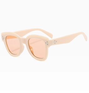 Detail view of cream thick frame sunglasses with orange lenses and metal rivets