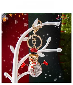 Macro detail of snowman keychain with sparkling rhinestones and golden lobster clasp