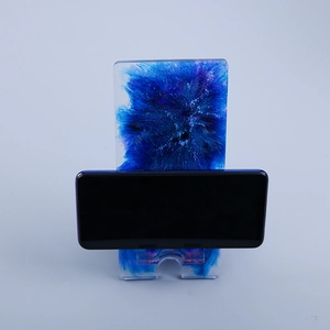 Detail of DIY phone stand resin mold with blue and white alcohol ink art style design