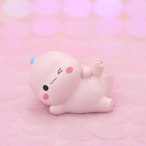 Cute pink cartoon dinosaur cake topper figurine laying down for birthday gift decoration