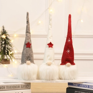 Three Christmas gnomes with felt hats and long white fur beards for holiday home decor