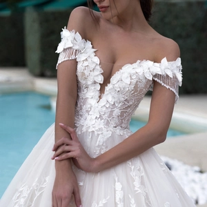 Elegant white V-neck wedding dress with 3D floral lace, fringe sleeves and tulle skirt