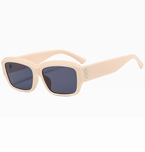 Detail view of vintage square sunglasses with beige frames and silver metal accents