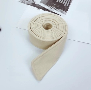Detailed close-up of apricot wool coat belt showing thick woven texture and stitching