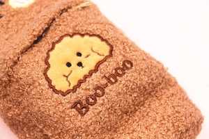 Detailed close-up of a brown fleece pouch with a cute dog embroidery and Boo-boo text