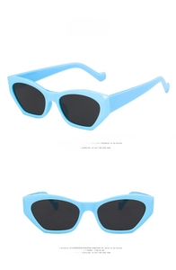 Front and side views of irregular light blue geometric sunglasses with dark grey lenses