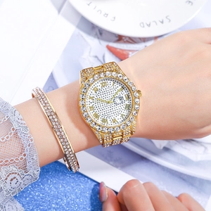 Luxury gold women's watch and diamond-set bracelet set with roman numeral dial