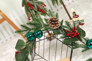 Detail of Christmas garland with pine cones, red berries, and green ornaments