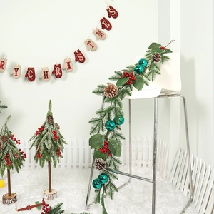 Peacock green Christmas garland with pine cones, red berries, and festive plaid banner