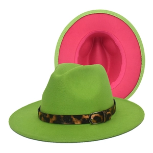 Detail view of two-tone wool fedora with green exterior, pink interior, and leopard band