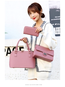 Detailed view of mauve woven pattern three-piece bag set worn by model for fashion styling