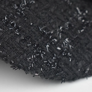 Close-up of black tweed fabric with shimmering sequins on a stylish navy peak cap