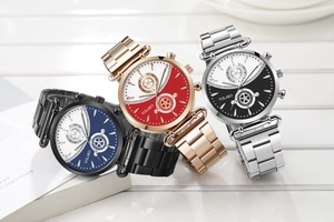 Three fashion steel quartz watches with two-tone wave pattern dial on a white wood surface
