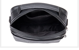 Top view of black leather messenger bag showing zipper main pocket and fabric lining