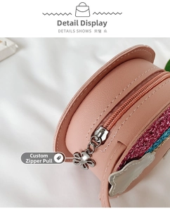 Close-up of a pink girl's rainbow purse showing custom floral metal zipper pull detail