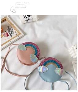 Detail view of pink and blue girls' glitter rainbow round PU leather crossbody bags