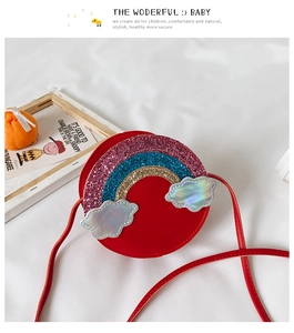 Detail of red children's rainbow crossbody bag with sparkling clouds and red strap