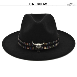 Detail of the vintage bull head ornament on a black wool fedora hat with ethnic band