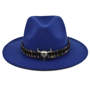 Detail of blue wool fedora featuring a colorful woven band and silver bull skull accent